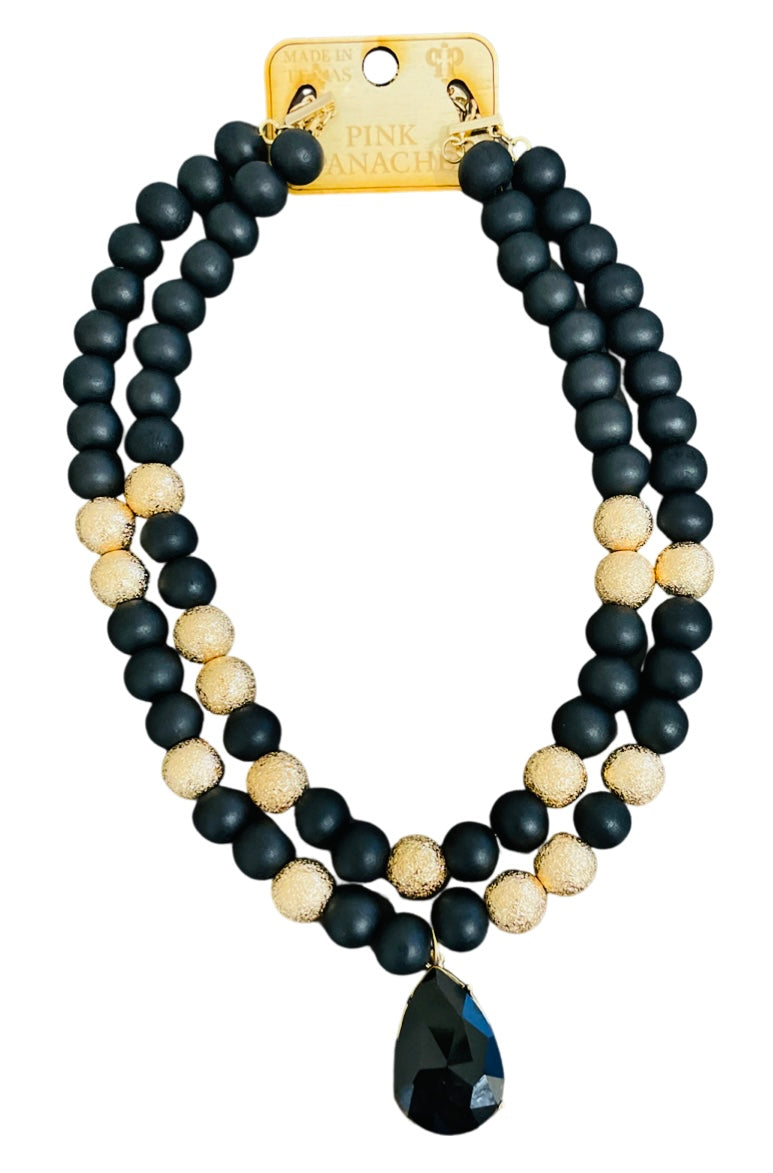 Wood and gold tone bead necklace with rhinestone teardrop charm