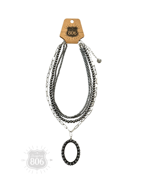 Burnished silver necklace, oval stone pendant