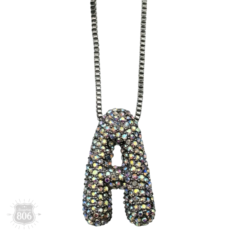 Rhinestone letter pendant on silver necklace