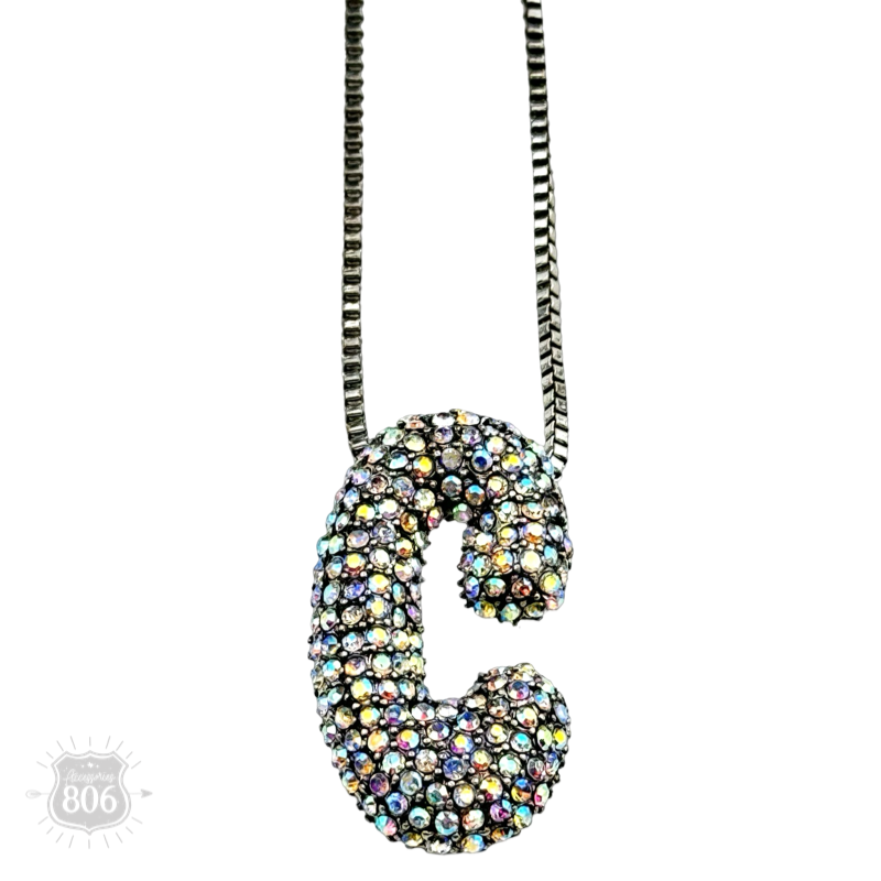 Rhinestone letter pendant on silver necklace