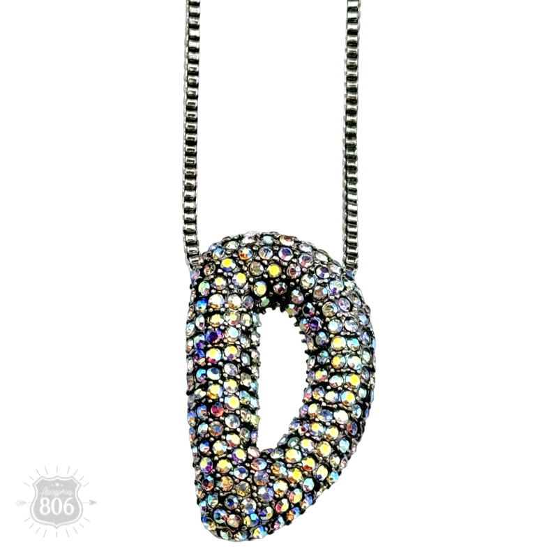 Rhinestone letter pendant on silver necklace
