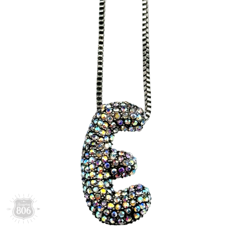 Rhinestone letter pendant on silver necklace