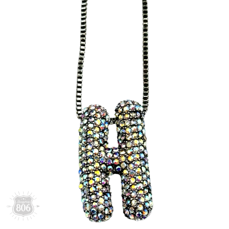 Rhinestone letter pendant on silver necklace
