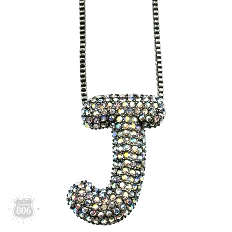Rhinestone letter pendant on silver necklace