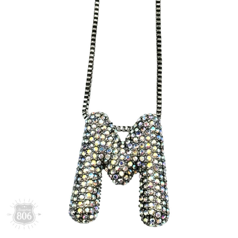 Rhinestone letter pendant on silver necklace