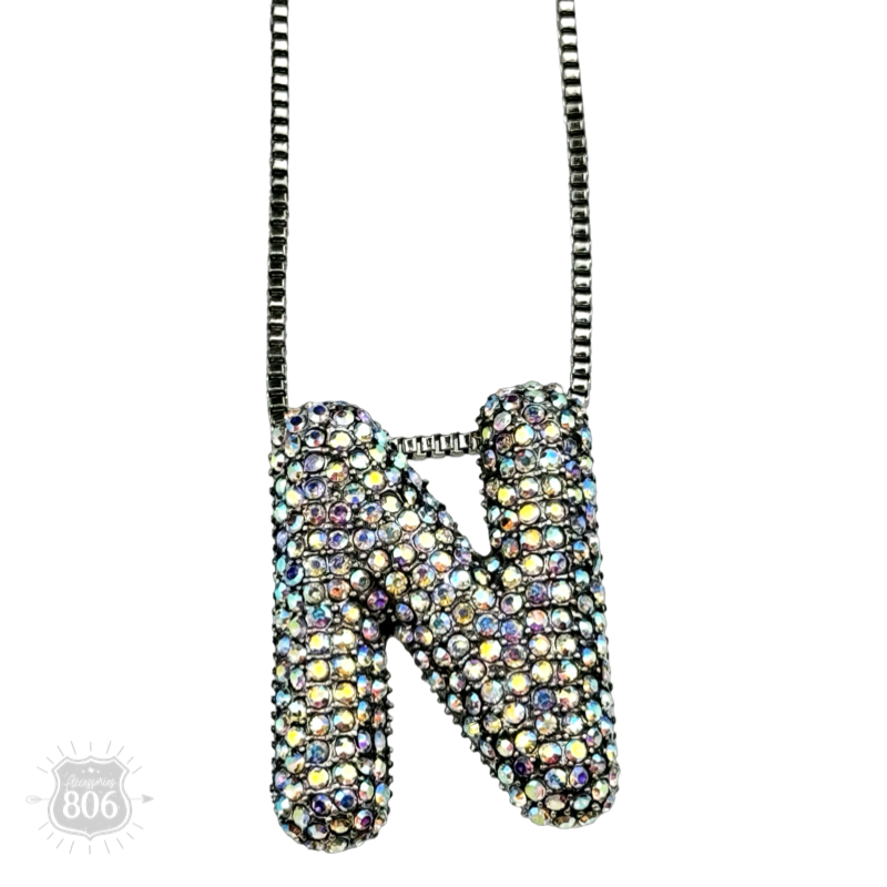 Rhinestone letter pendant on silver necklace