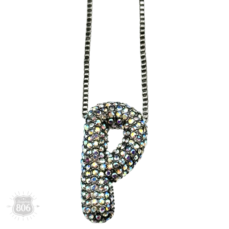 Rhinestone letter pendant on silver necklace