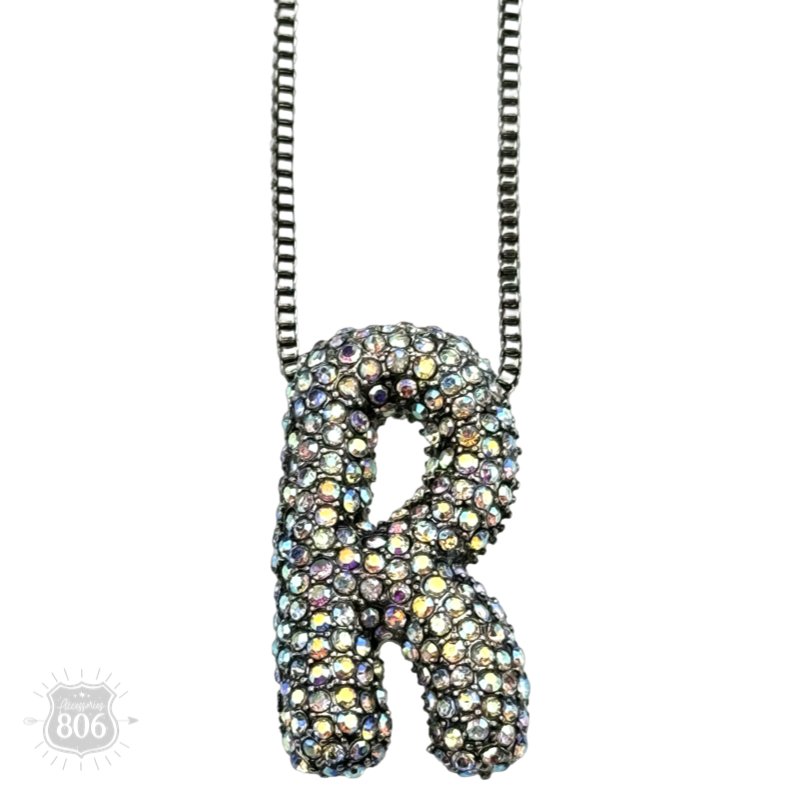 Rhinestone letter pendant on silver necklace