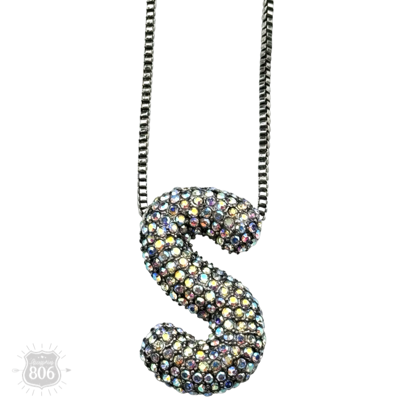 Rhinestone letter pendant on silver necklace