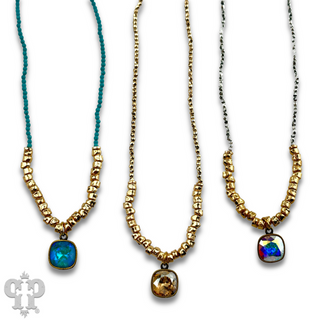 Seed and chunky gold bead necklace with Austrian crystal pendant