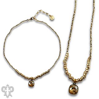 Seed and chunky gold bead necklace with Austrian crystal pendant