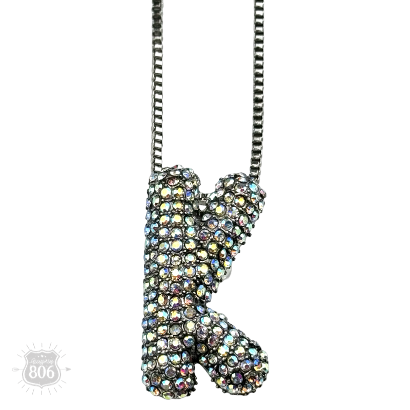 Rhinestone letter pendant on silver necklace