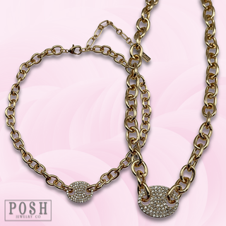 Gold chain link choker with pave oval charm