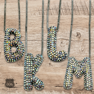 Rhinestone letter pendant on silver necklace