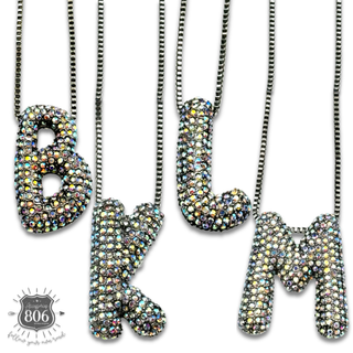 Rhinestone letter pendant on silver necklace