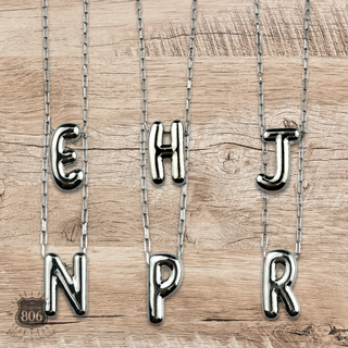 Silver letter pendant on necklace, initial monogram