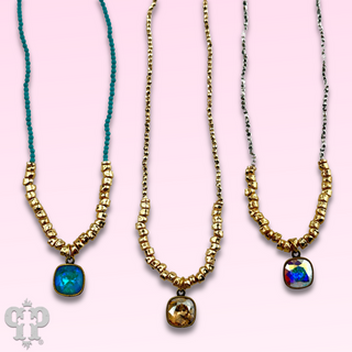 Seed and chunky gold bead necklace with Austrian crystal pendant