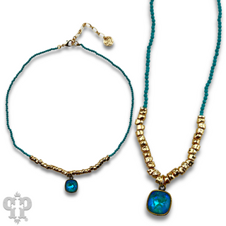 Seed and chunky gold bead necklace with Austrian crystal pendant